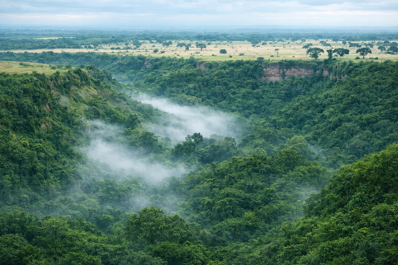 Image of a scenic view of part of the rift valley showing mild mist over vegetation in the valley and escarpments 